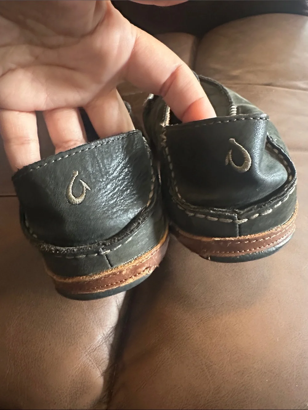 OluKai Men's Black Slip-On Loafers with Brown Trim